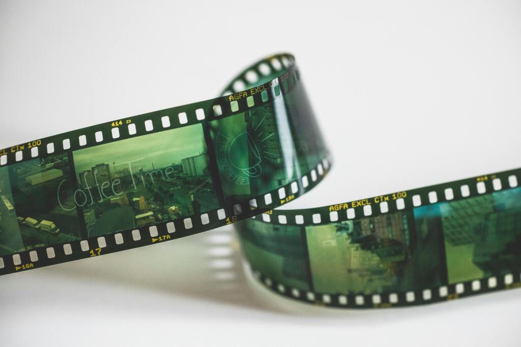 Close-up of a vintage AGFA filmstrip with cinematic exposures, evoking nostalgia.